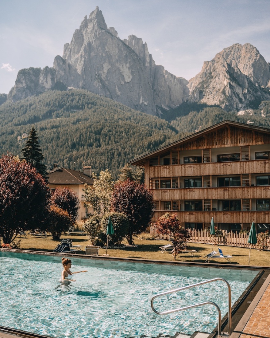 ArtNatur Dolomites pool with the Sciliar behind it